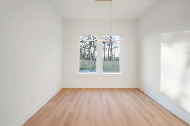 a view of wooden floor and a chandelier in a room