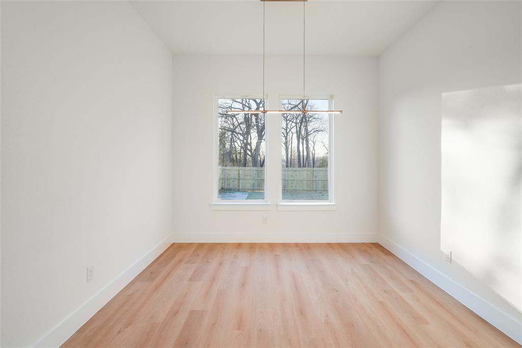 1147 Riverwood Road Dallas, TX 75217 - Photo 9 of 26 a view of wooden floor and a chandelier in a room