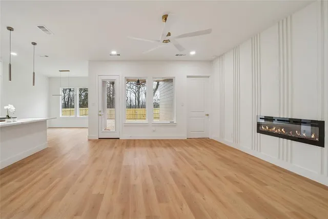 a view of a kitchen with wooden floor and electronic appliances