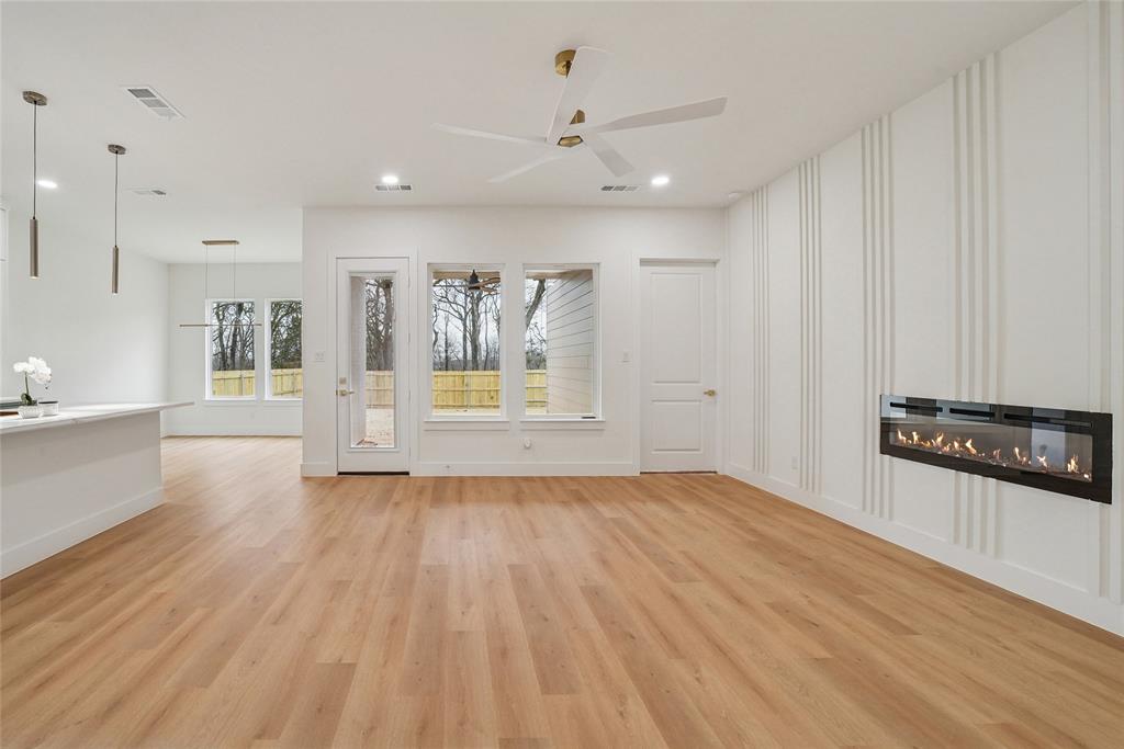 1147 Riverwood Road Dallas, TX 75217 - Photo 10 of 26 a view of a kitchen with wooden floor and electronic appliances
