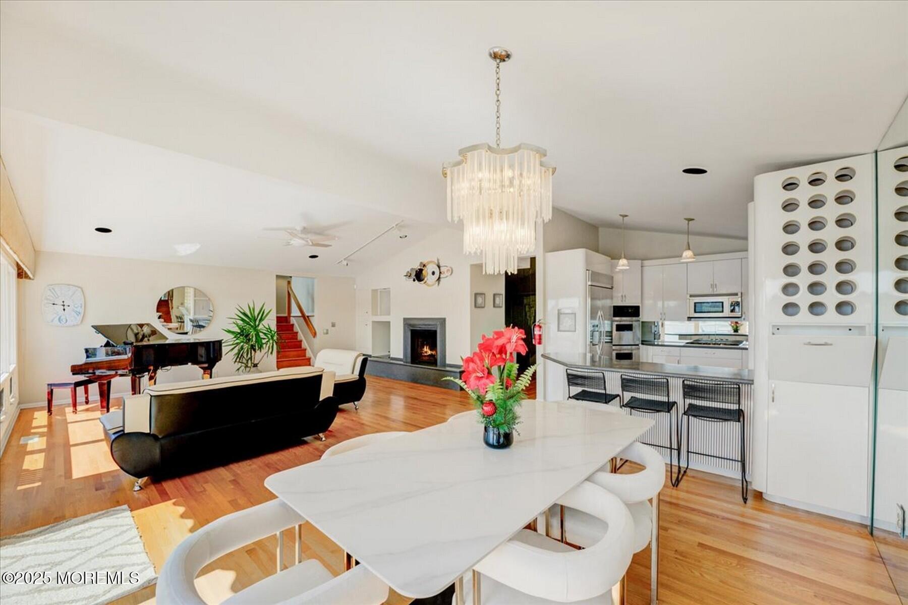 74 Seneca Place Oceanport, NJ 07757 - Photo 22 of 45 a view of a dining room and kitchen with furniture wooden floor and a chandelier