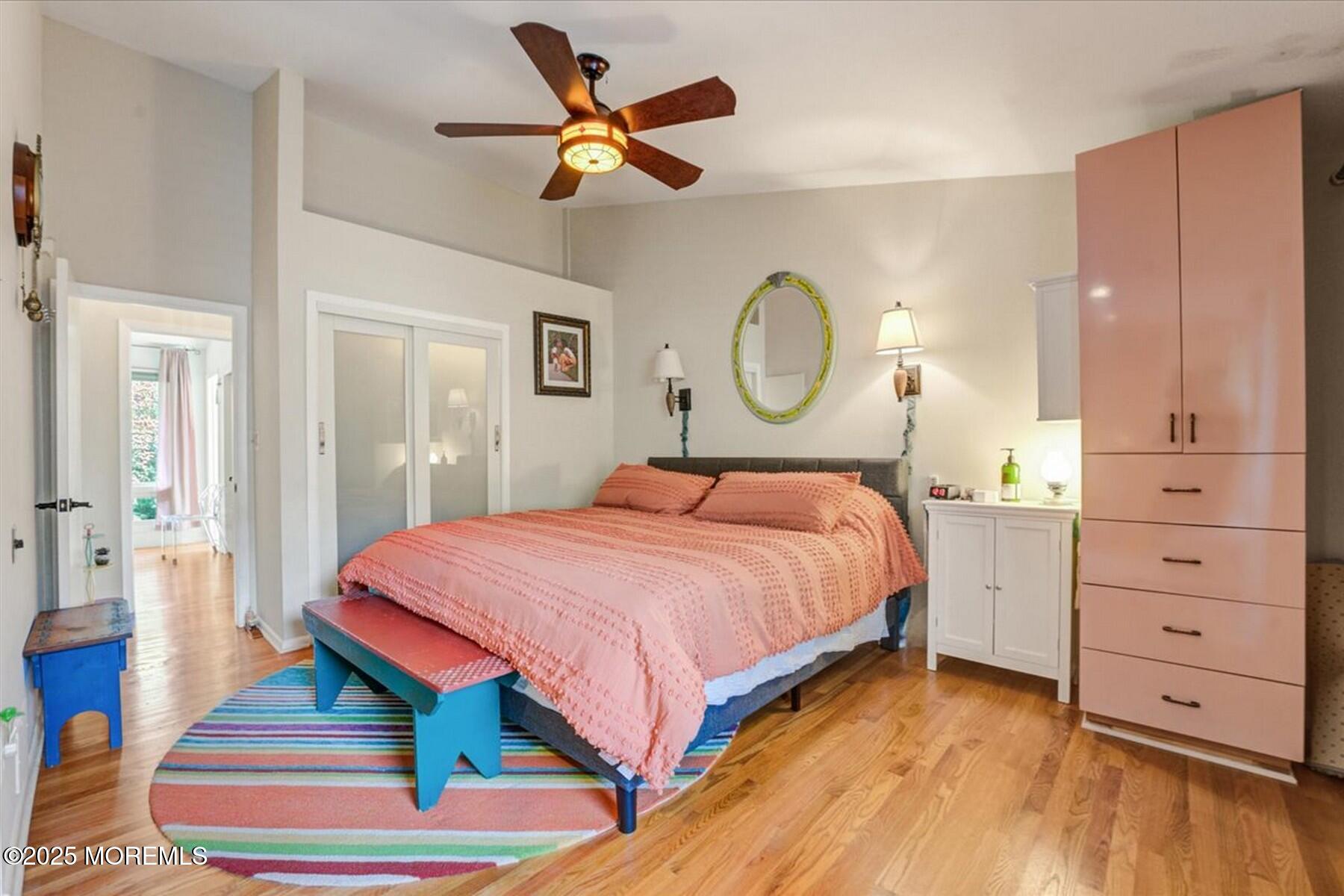 74 Seneca Place Oceanport, NJ 07757 - Photo 36 of 45 a bedroom with a bed a dresser and a chandelier