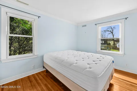 a bedroom with a bed and a window with outer view