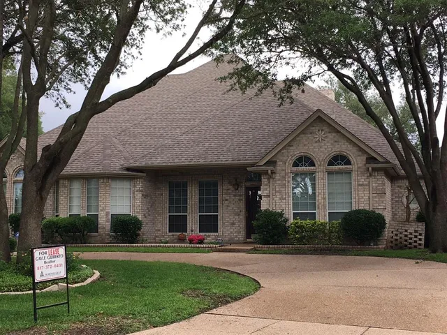 a front view of a house with a yard and a garden