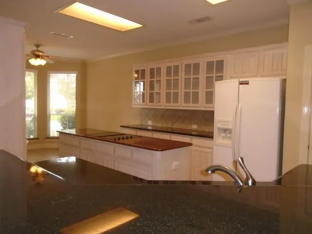 a kitchen with a refrigerator and a sink