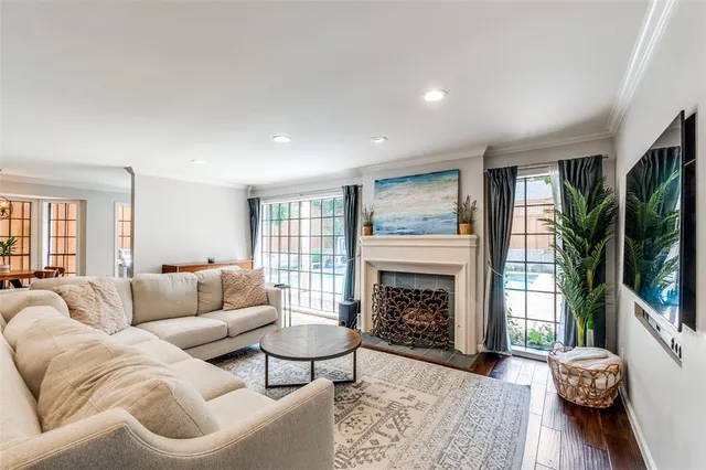 a living room with furniture flat screen tv and a fireplace