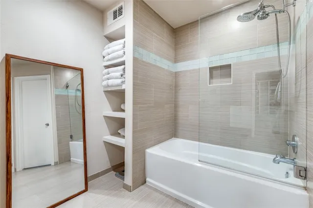 a bathroom with a bathtub and a shower