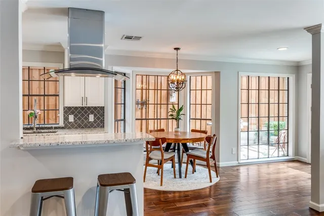 a dining room with wooden floor and a window