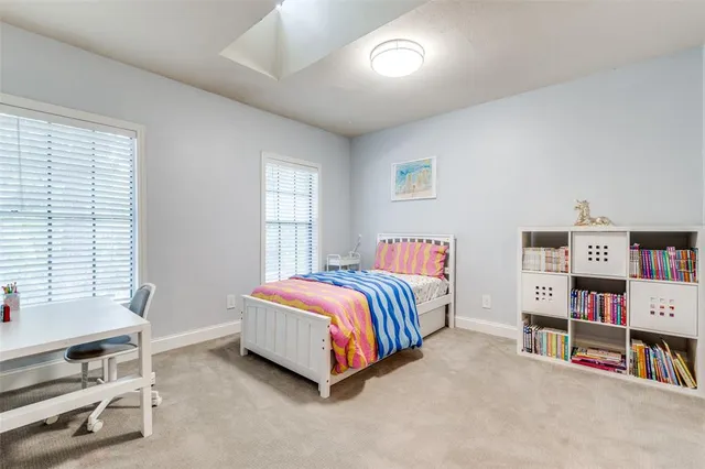 a spacious bedroom with a bed and a large window