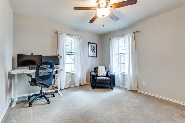 a view of a workspace with furniture and a window