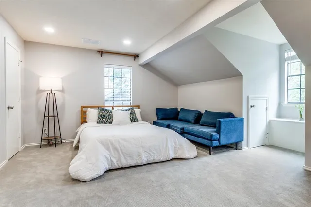 a bedroom with a bed and a couch