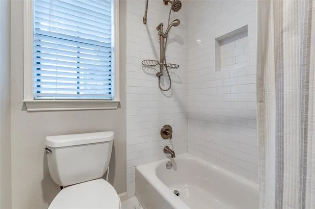a bathroom with a toilet and a bathtub