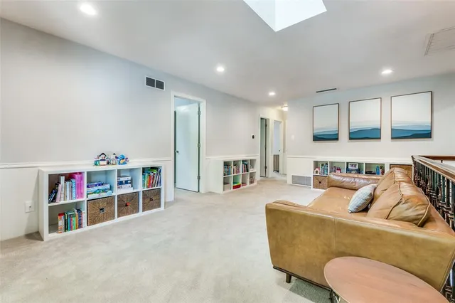 a living room with furniture and a book shelf