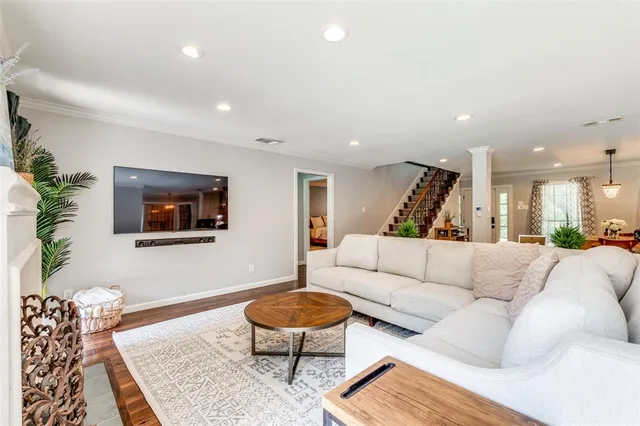 a living room with furniture and a wooden floor