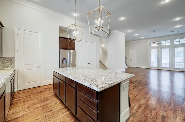 a kitchen with a counter space cabinets and wooden floor