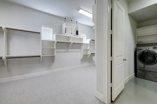 a view of empty room with wooden floor and electronic appliances