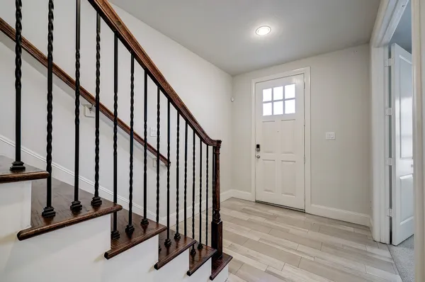 a view of an entryway with wooden floor