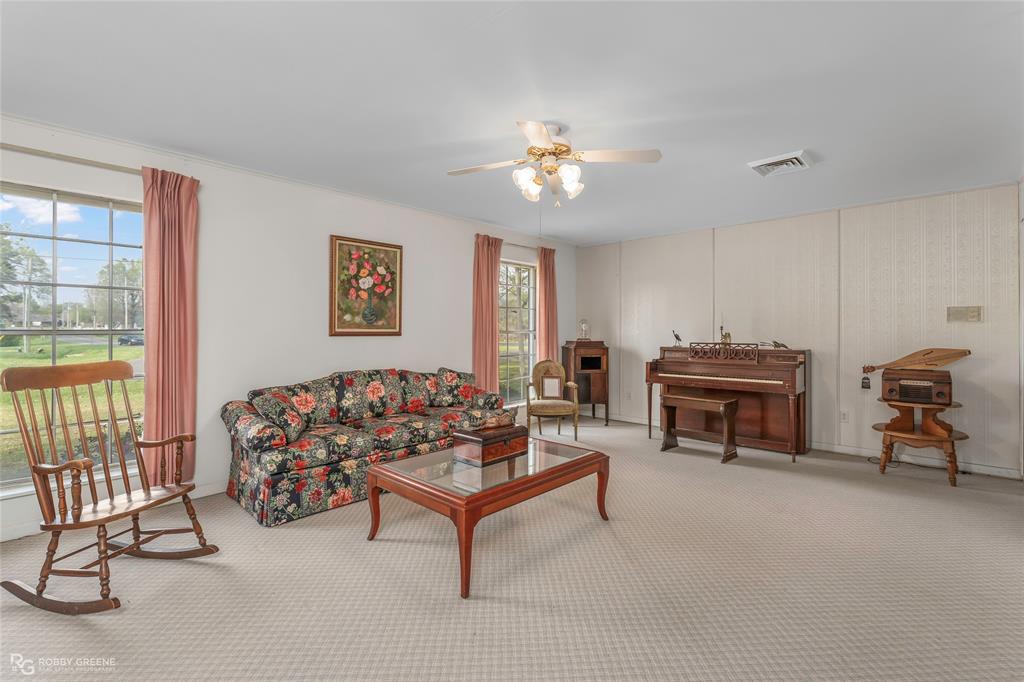 701 Palmetto Road Benton, LA 71006 - Photo 17 of 28 a living room with furniture a piano and a window