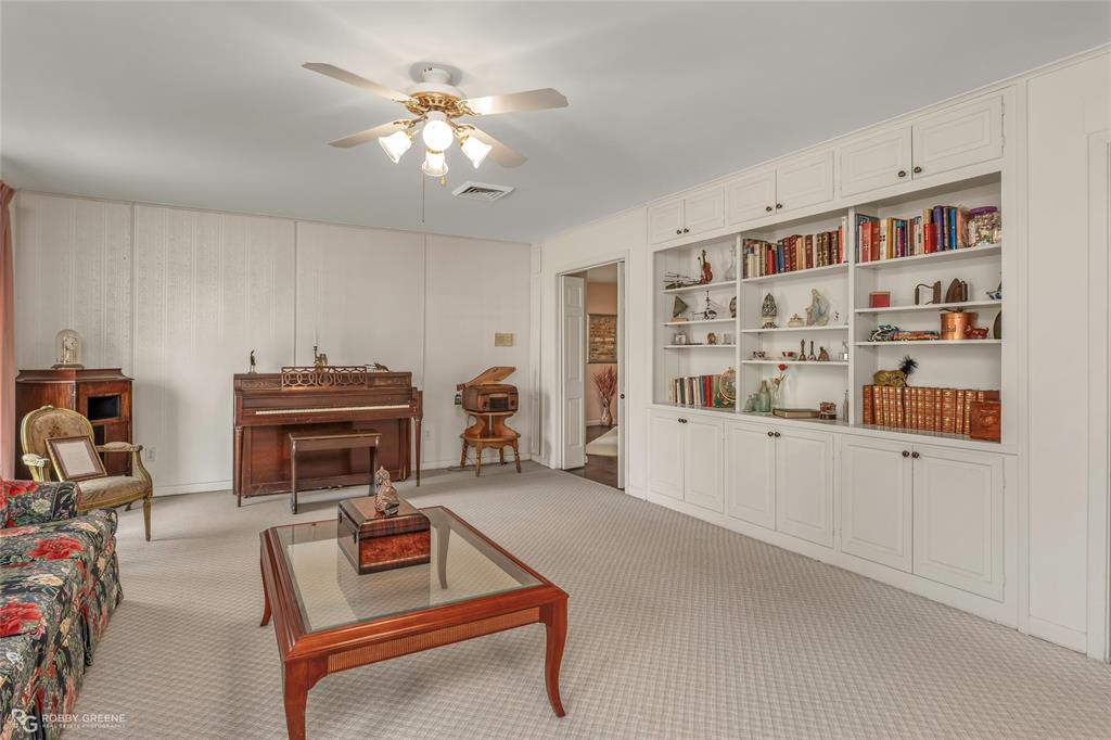 701 Palmetto Road Benton, LA 71006 - Photo 18 of 28 a living room with furniture a piano and a bookshelf
