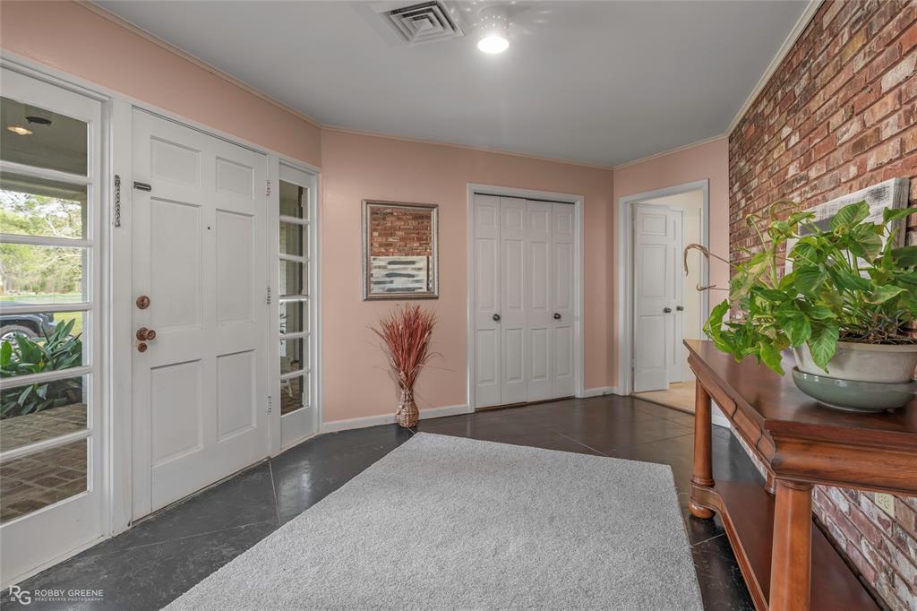 701 Palmetto Road Benton, LA 71006 - Photo 26 of 28 en empty room with wooden floor and windows