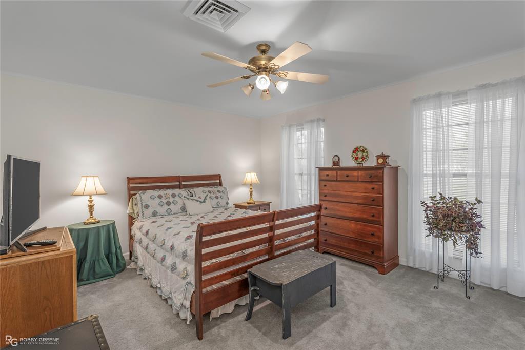 701 Palmetto Road Benton, LA 71006 - Photo 28 of 28 a bedroom with a bed and a chandelier