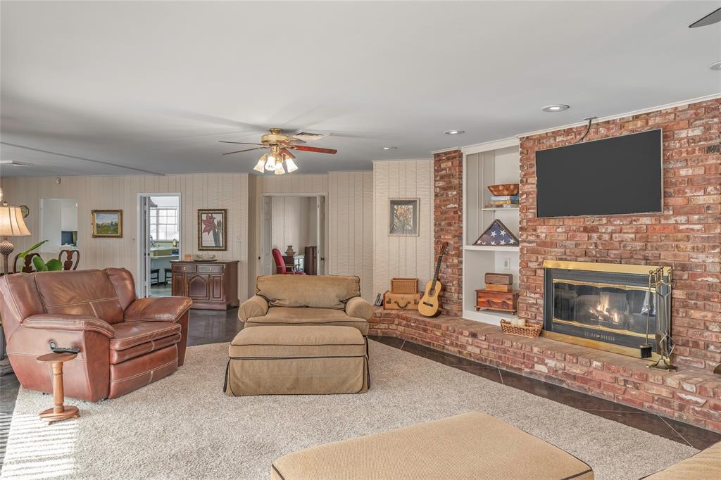 701 Palmetto Road Benton, LA 71006 - Photo 10 of 28 a living room with furniture a flat screen tv and a fireplace