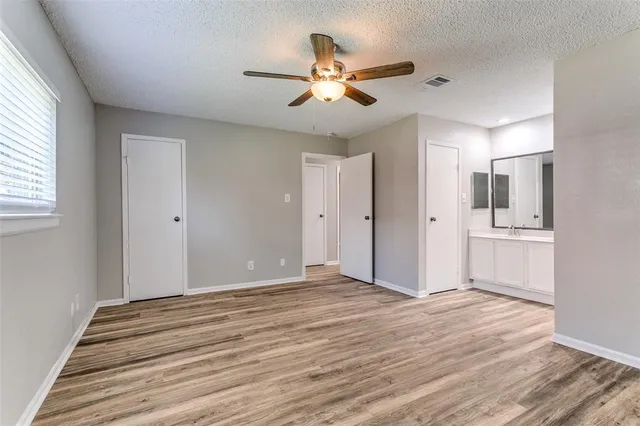 a view of a livingroom with a ceiling fan and window