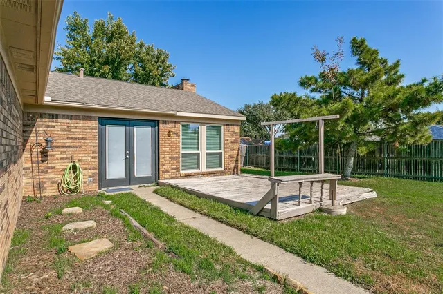 a view of a house with a backyard and a patio