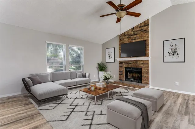 a living room with furniture a flat screen tv and a fireplace