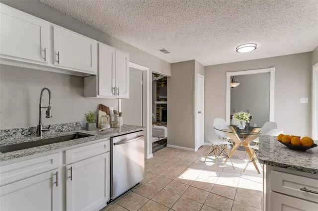 a kitchen with stainless steel appliances granite countertop a sink and cabinets