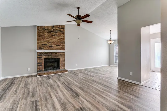wooden floor fireplace and natural light in room