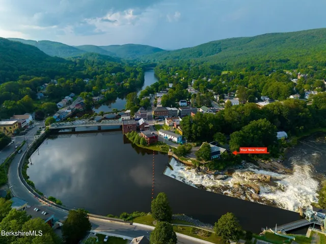 an aerial view of a house with a yard