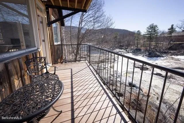 a view of balcony with wooden floor