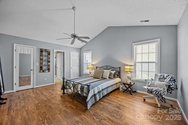 a spacious bedroom with a bed and window