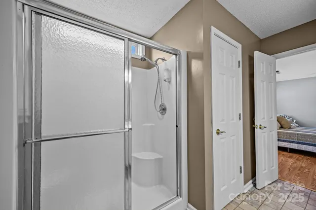 a bathroom with a glass shower door and a toilet