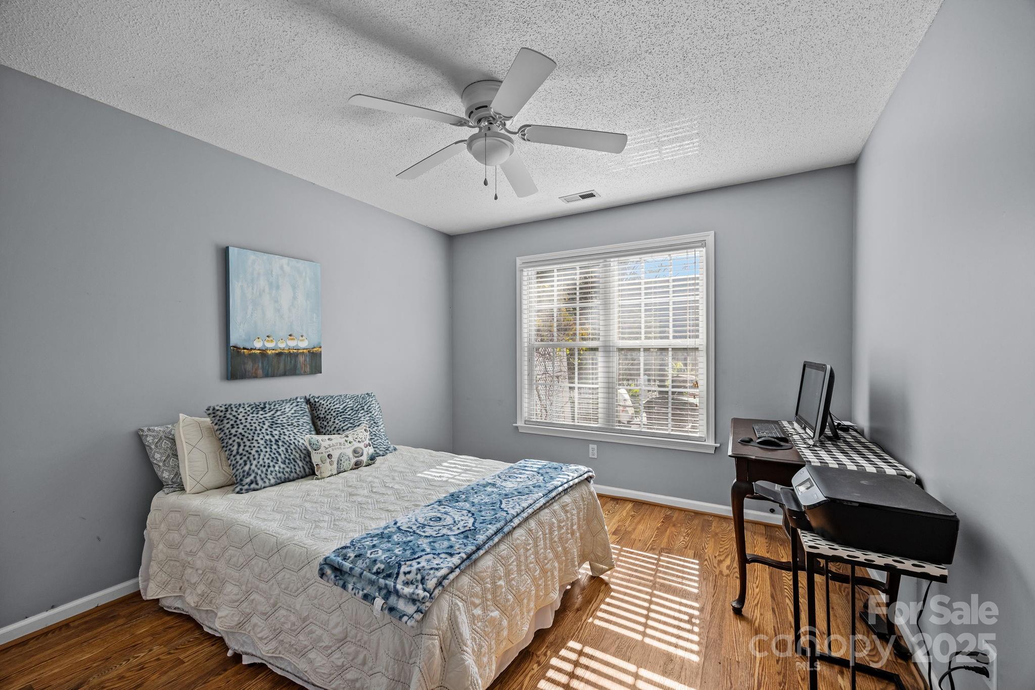 255 Stonehollow Road Fletcher, NC 28732 - Photo 19 of 32 a bedroom with a bed and wooden floor