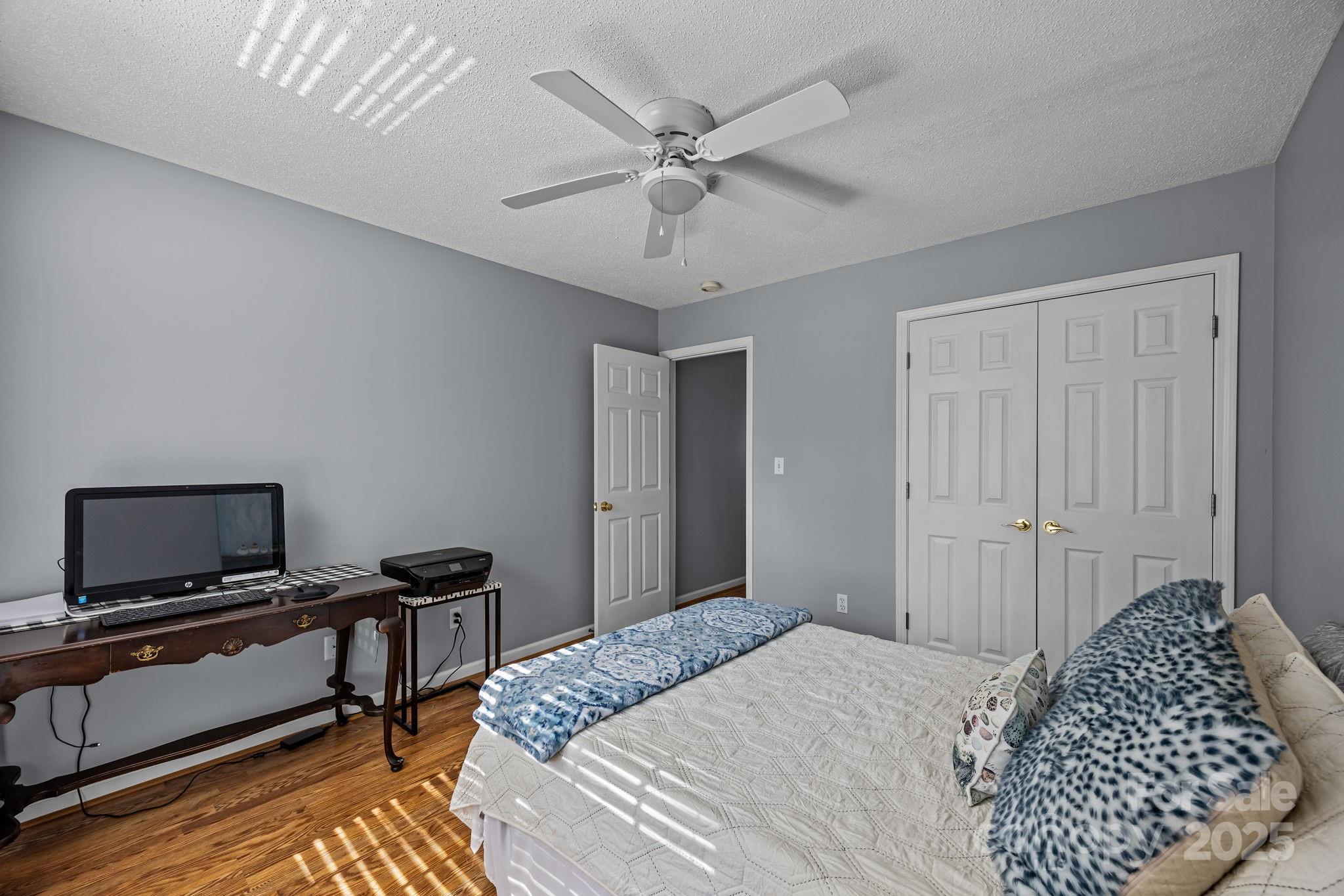 255 Stonehollow Road Fletcher, NC 28732 - Photo 20 of 32 a bedroom with a bed and a chandelier