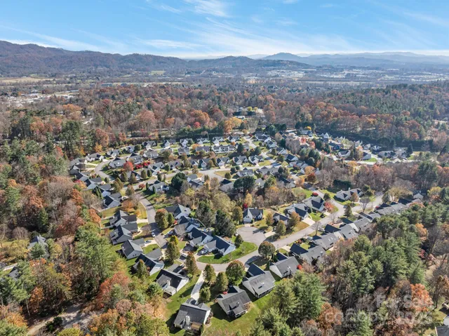 an aerial view of residential houses with outdoor space and mountain view