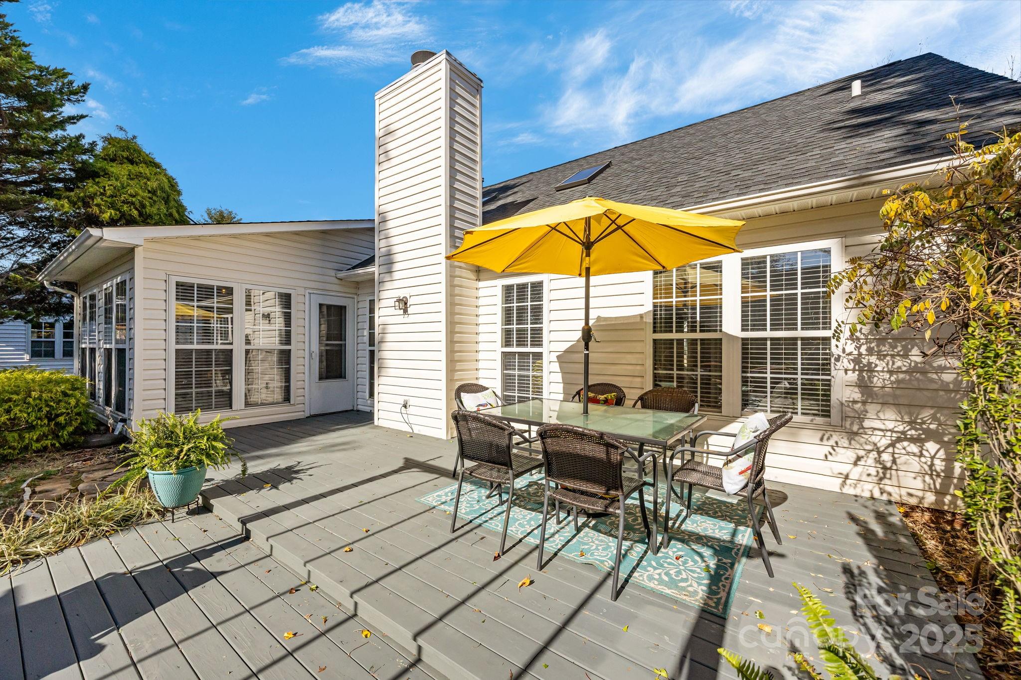 255 Stonehollow Road Fletcher, NC 28732 - Photo 4 of 32 a view of a patio with a table and chairs under an umbrella