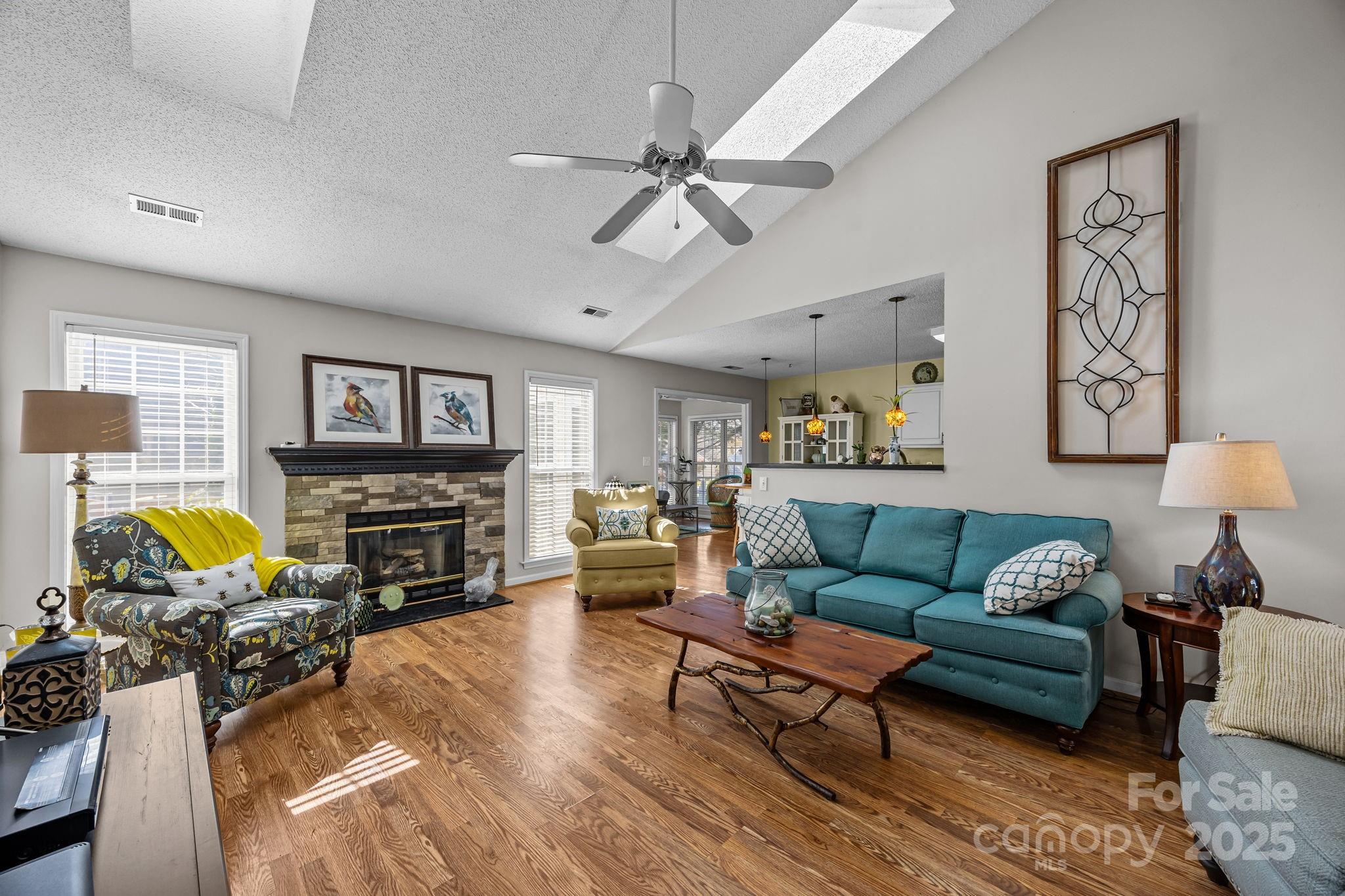 255 Stonehollow Road Fletcher, NC 28732 - Photo 6 of 32 a living room with furniture a fireplace and a flat screen tv