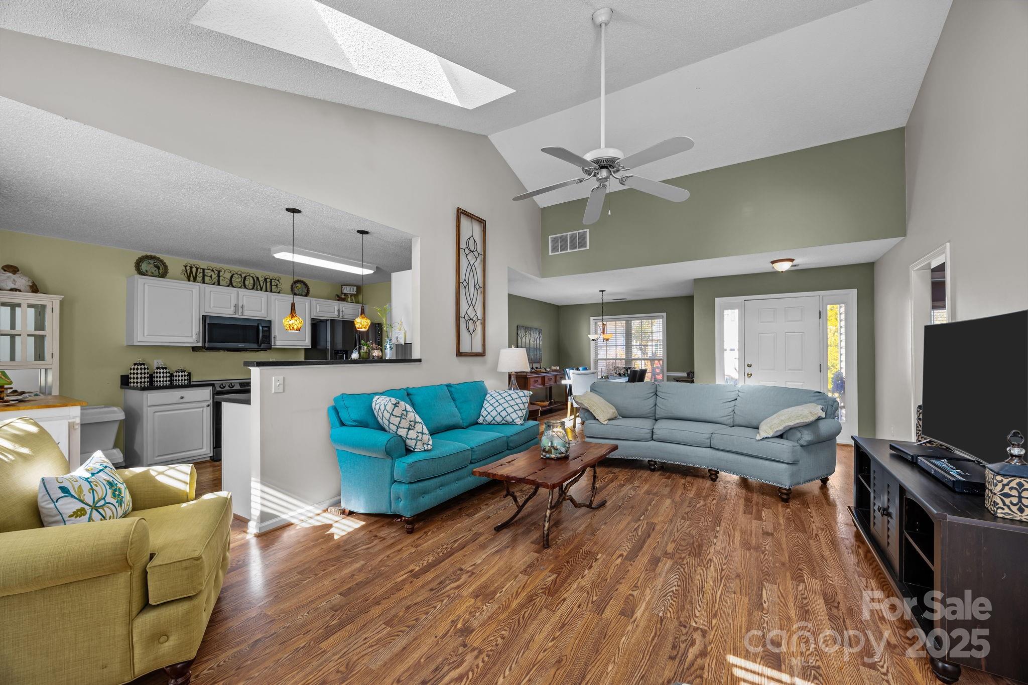 255 Stonehollow Road Fletcher, NC 28732 - Photo 7 of 32 a living room with furniture flat screen tv and wooden floor