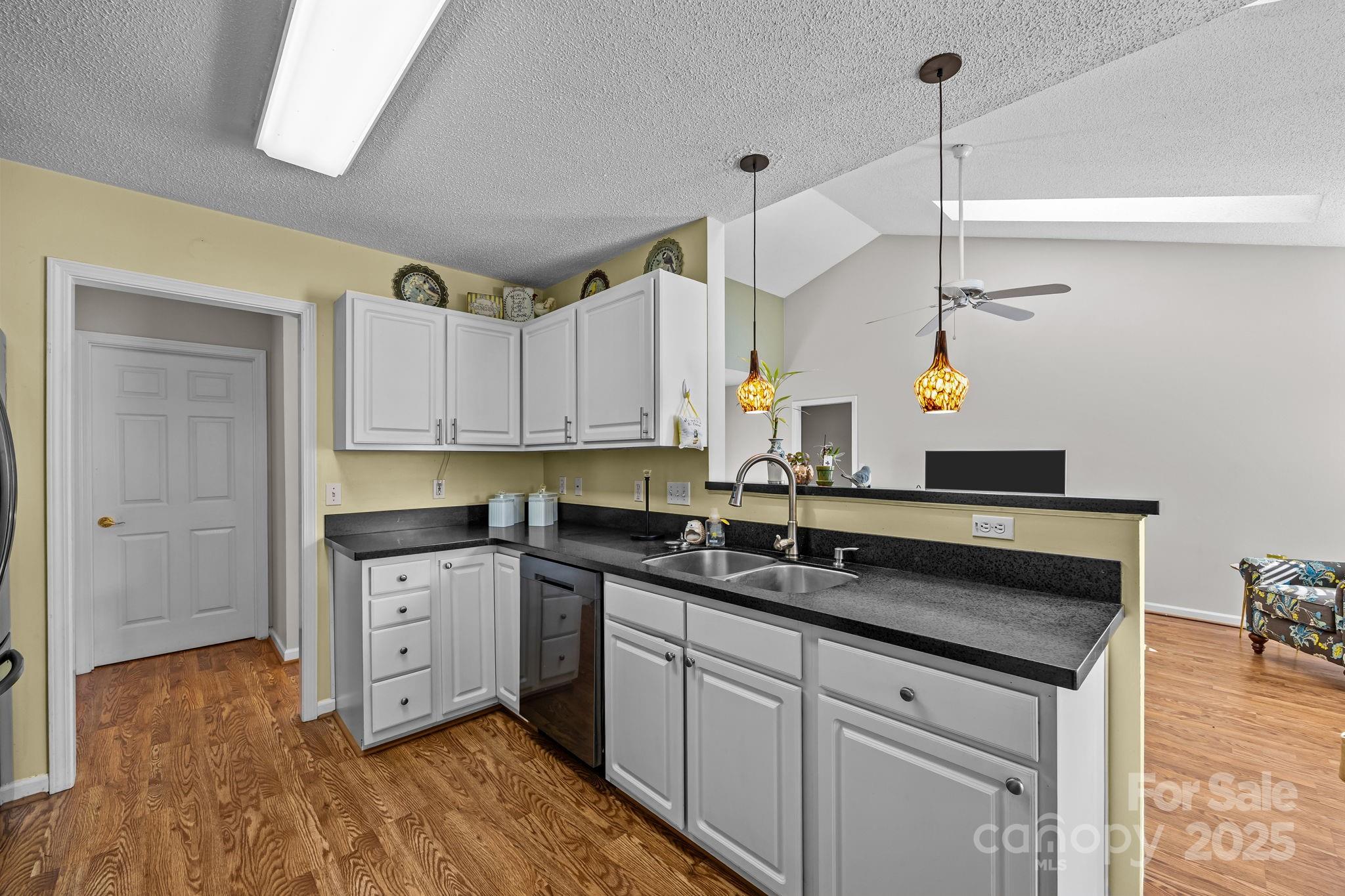 255 Stonehollow Road Fletcher, NC 28732 - Photo 10 of 32 a kitchen with granite countertop a sink cabinets and stainless steel appliances