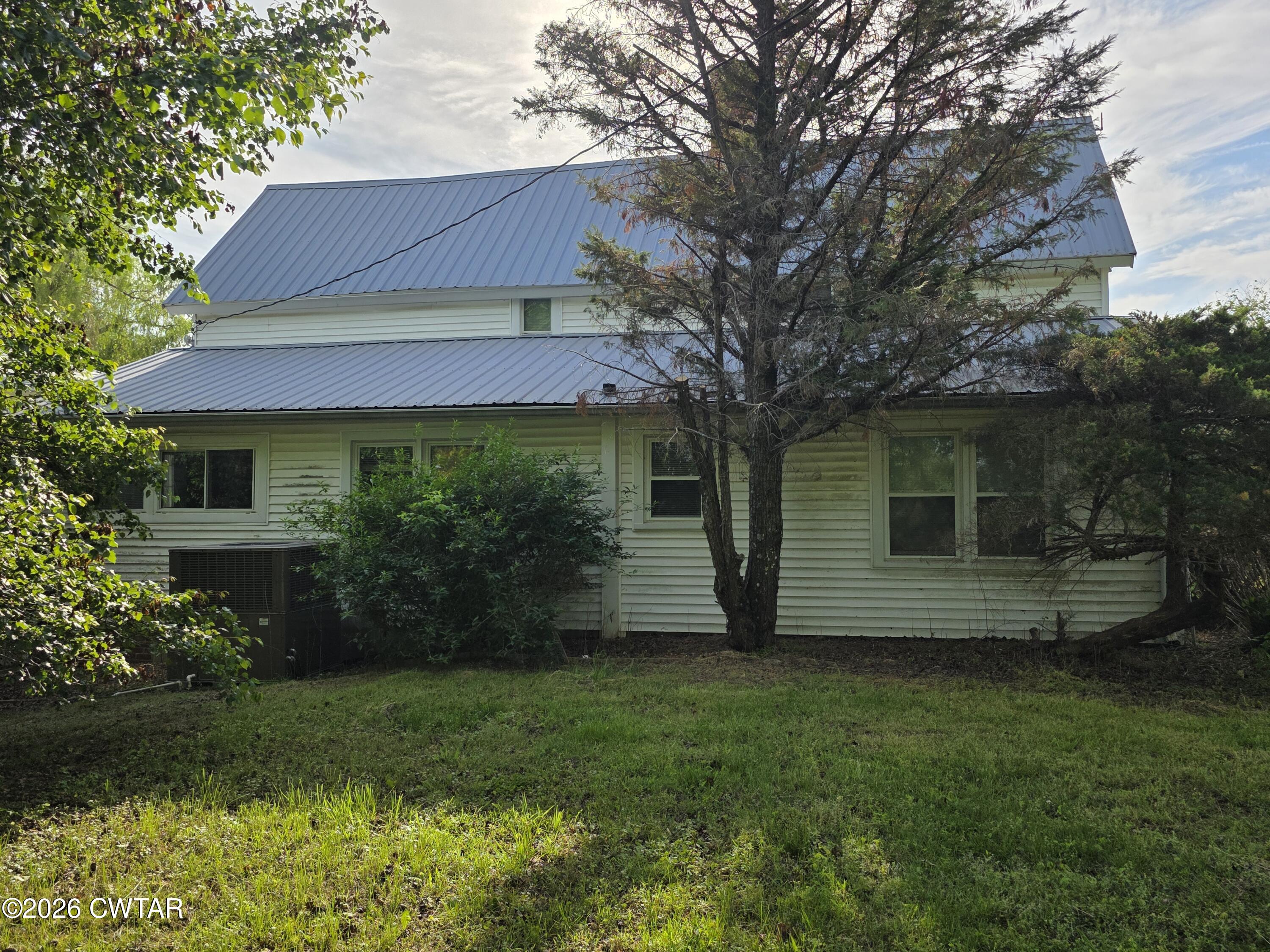 111 Leighton County Line Road Denmark, TN 38391 - Photo 2 of 53 a front view of a house with a garden