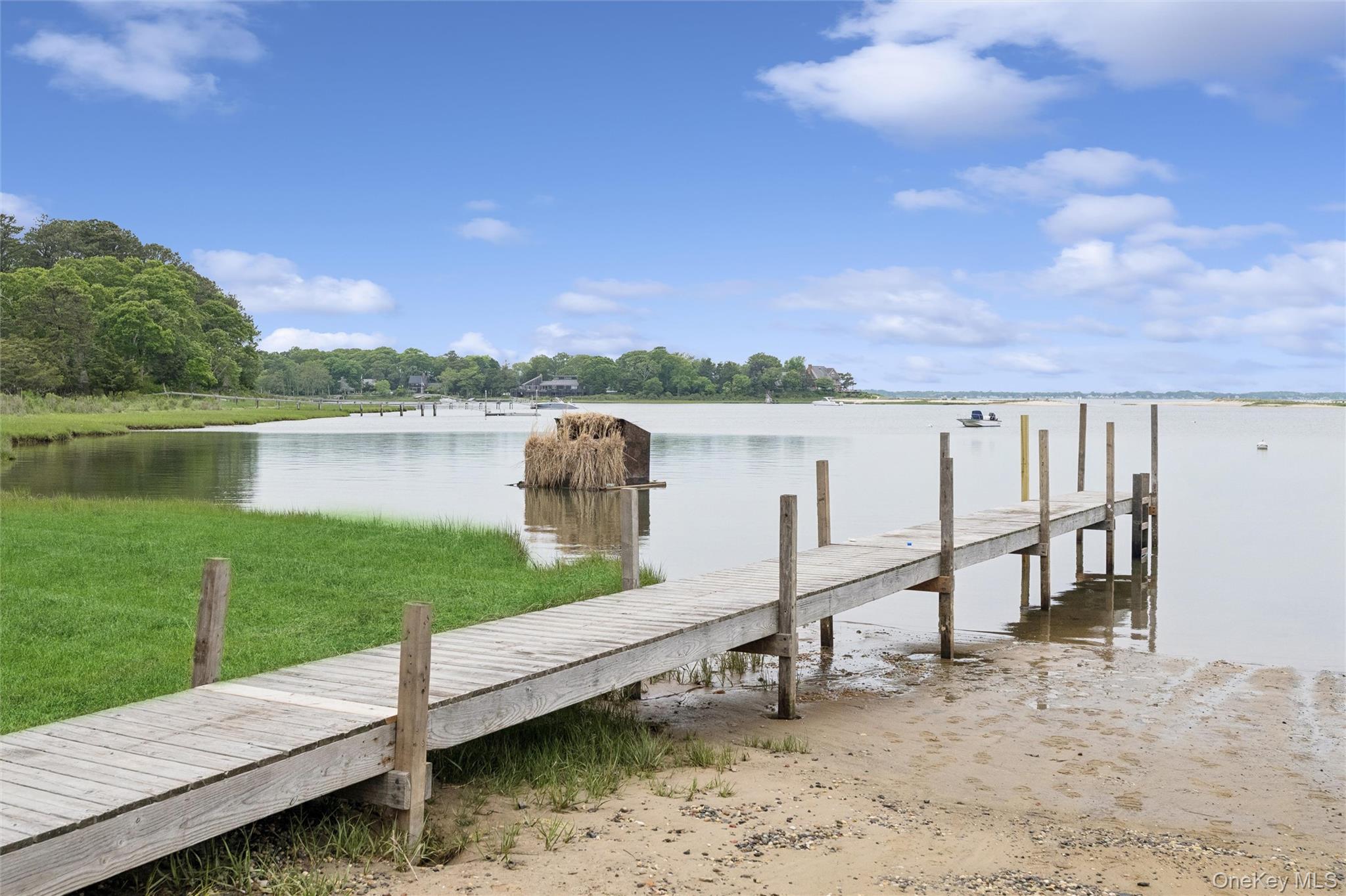 131 Red Creek Road Hampton Bays, NY 11946 - Photo 27 of 35 a view of a lake with a mountain in the background