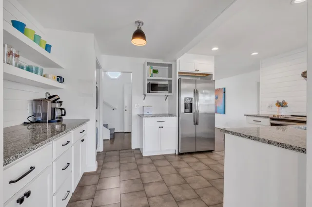 a living room with furniture and a kitchen view