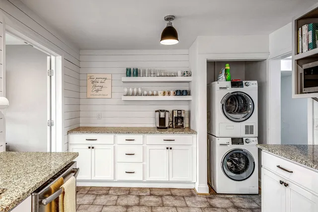 a living room with furniture and large windows
