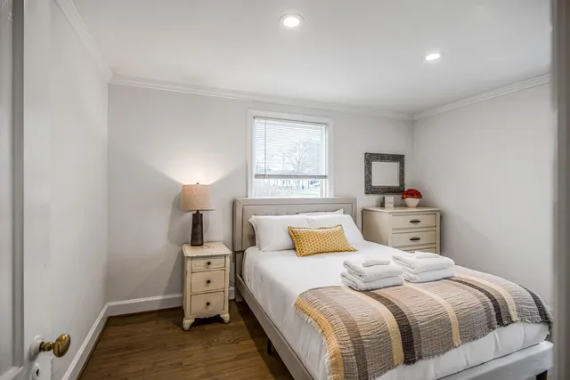 a bedroom with a bed and a mirror