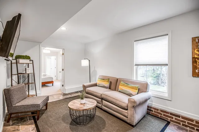 a bathroom with a granite countertop sink a toilet and a mirror