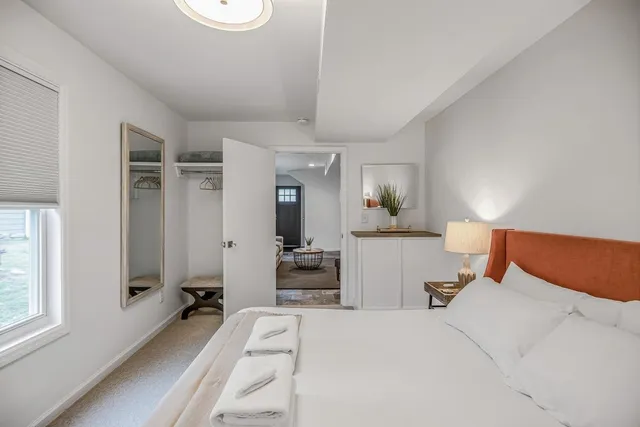a bathroom with a granite countertop sink a mirror and shower