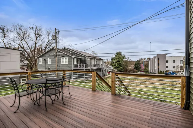 a view of a house with a big yard and potted plants